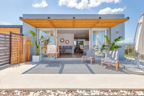 a house with a patio with a swing at Chania Urban Living - Live like a local in Chania Town