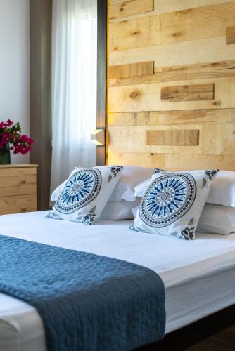 a bedroom with a bed with blue and white pillows at Chania Urban Living - Live like a local in Chania Town