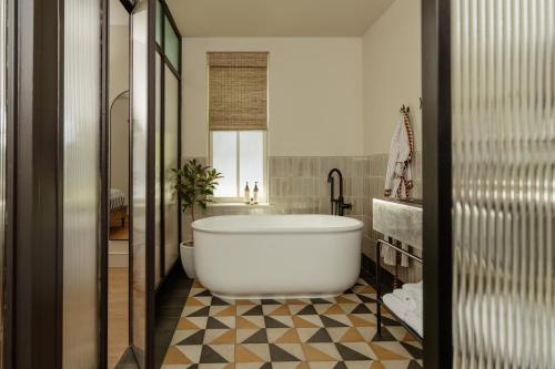a bathroom with a large white tub in a room at Anna and Bel in Philadelphia