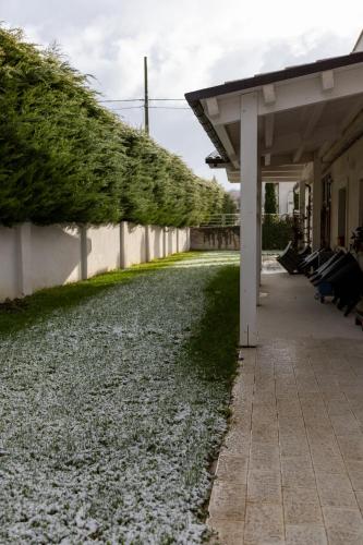 a porch with a row of benches next to a building at River Hotel in Castel di Sangro
