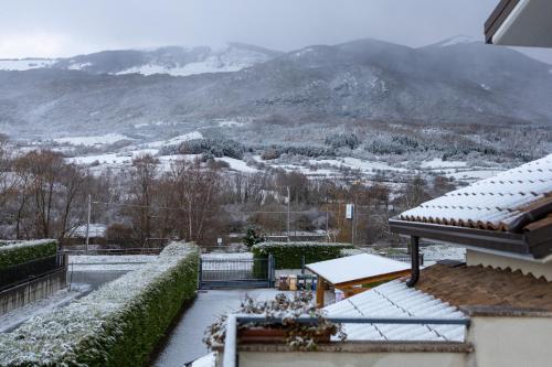 a view of a snowy mountain from a house at River Hotel in Castel di Sangro