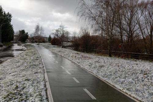 a wet road with snow on the side of it at River Hotel in Castel di Sangro