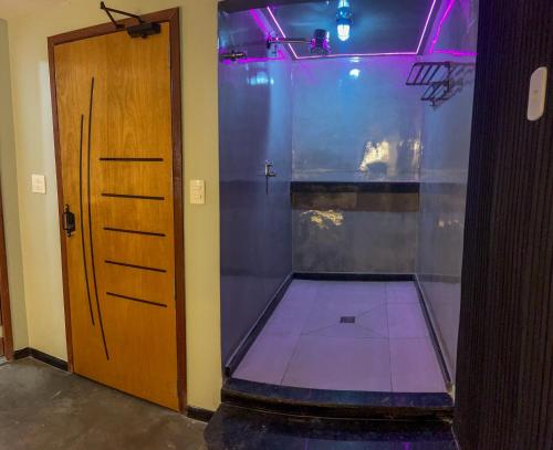 a room with a shower with a glass door at Bella Ciao Hostel in Rio de Janeiro