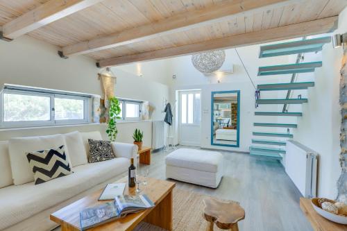a living room with a white couch and stairs at Chania Urban Living - Live like a local in Chania Town
