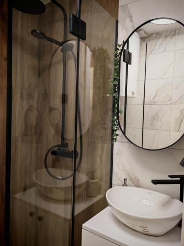 a bathroom with a sink and a shower at Azulejo Apartment in Novi Beograd