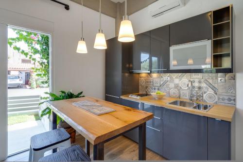 a kitchen with a wooden table and a sink at Chania Urban Living - Live like a local in Chania Town