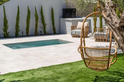 a swimming pool in a yard with a swing at Chania Urban Living - Live like a local in Chania Town