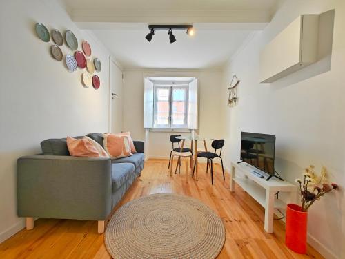 a living room with a couch and a table at The Ceramic - 2BR apt in Lisbon