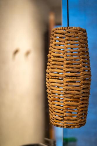 a wicker light fixture hanging from a wall at Witari Hotel Boutique in San Francisco