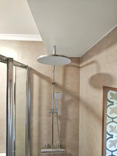 a shower with a light in a bathroom at The Ceramic - 2BR apt in Lisbon