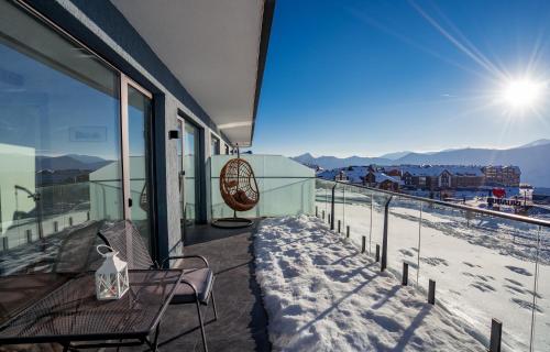 a balcony with a view of the snow covered mountains at Atrium New Gudauri in Gudauri