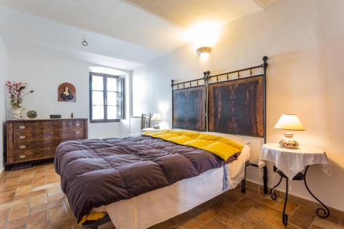 een slaapkamer met een groot bed met gele kussens bij Appartamento nel Castello presso Gubbio in Fossato di Vico