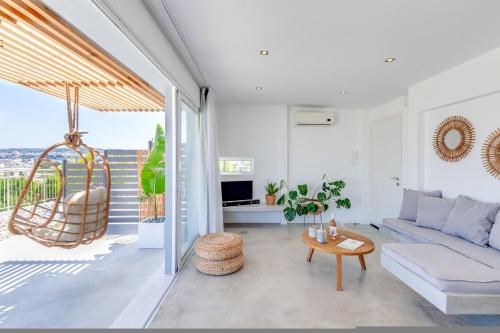 a living room with a couch and a table at Chania Urban Living - Live like a local in Chania Town