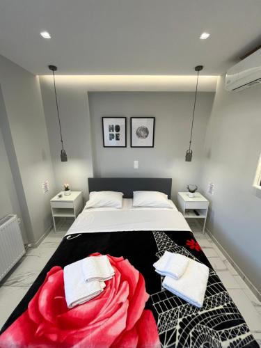 a bedroom with a bed with a red blanket on it at BlueLine apartment 1 in Loutraki