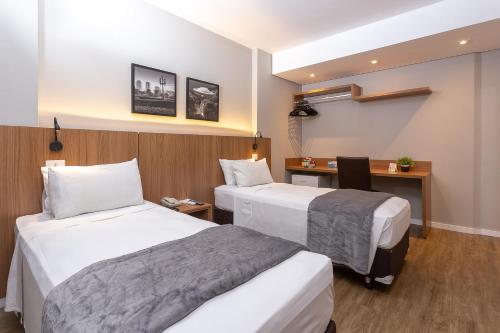 Кровать или кровати в номере Roochelle Hotel by Nobile