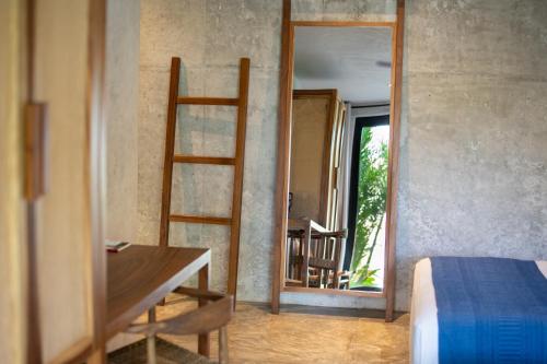 a bedroom with a desk and a ladder and a mirror at Witari Hotel Boutique in San Francisco