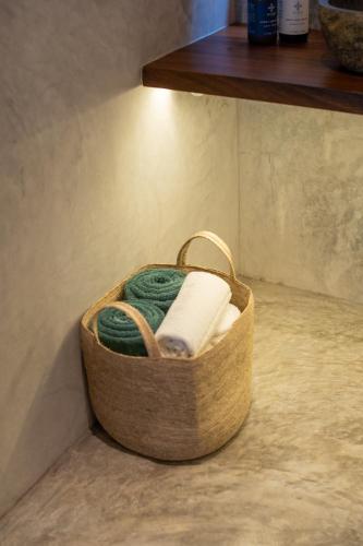 a wooden basket with yarn and towels on a shelf at Witari Hotel Boutique in San Francisco