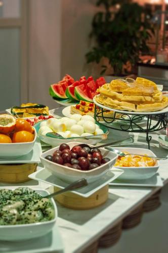 a buffet with plates of food on a table at Tequendama Suites Bogota in Bogotá