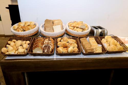 a table topped with trays of different types of pastries at Madero Hotel & Suites in La Paz