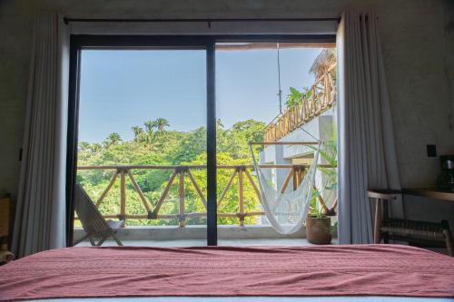 a bedroom with a bed and a large glass window at Witari Hotel Boutique in San Francisco