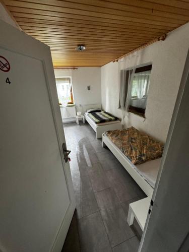 a room with two beds and a room with a door at Wohlfühlhaus Adelsried in Adelsried