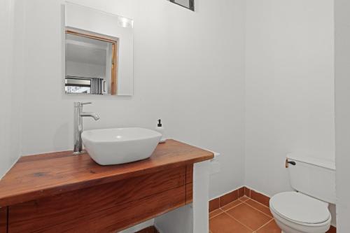 a bathroom with a sink and a toilet at Villas Vibras in Playa Avellana