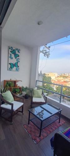 a living room with a table and chairs and a window at Dep #1 Basilio in Puerto Vallarta