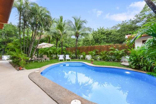 a swimming pool in the backyard of a house at Villas Vibras in Playa Avellana