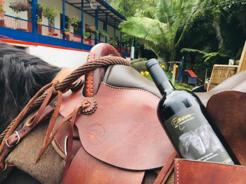 a bottle of wine in a horse saddle at Reserva Guadalajara - Cocora Valley in Salento