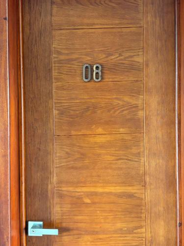 a wooden door with two numbers on it at Hotel Awazul Bacalar in Bacalar