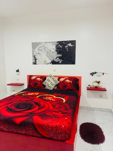 a bedroom with a red bed with red roses at Grace house jacuzzi in Saly Portudal