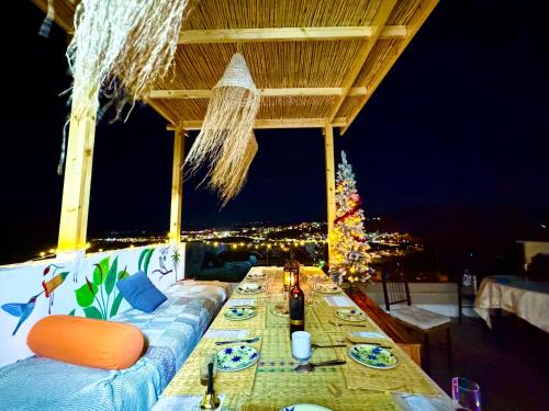 a long table on a balcony with a christmas tree at tayyurt host in Agadir