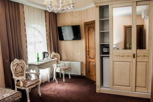 a living room filled with furniture and a tv at Aristokrat in Vinnytsya