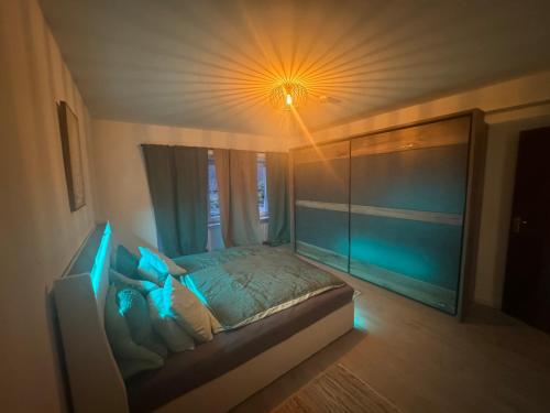a bedroom with a bed with a light on the ceiling at Ferienwohnung Sindorf in Kerpen