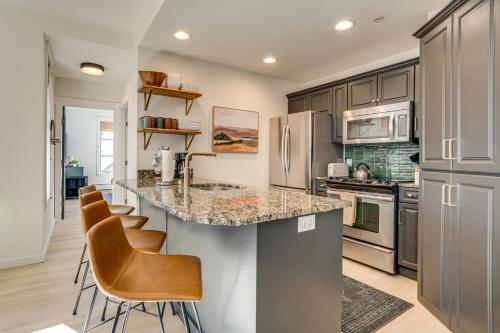 a kitchen with a counter and bar stools at Walk to Lifts Copper Mtn Condo in Center Village in Frisco