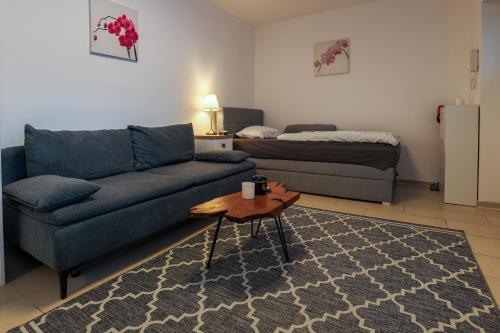 a living room with a couch and a coffee table at Central Messe Airport DUS Apartment with Terrace in Duisburg