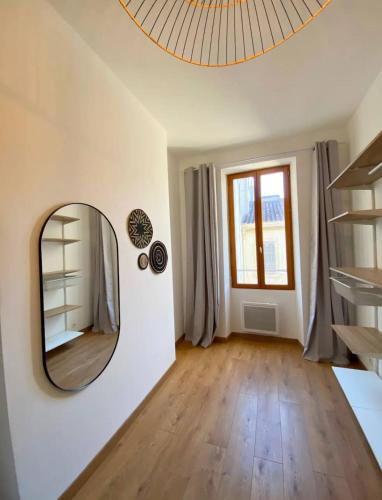 Cette chambre dispose de parquet et d'un miroir mural. dans l'établissement Le Mayhana - Joliette, à Marseille