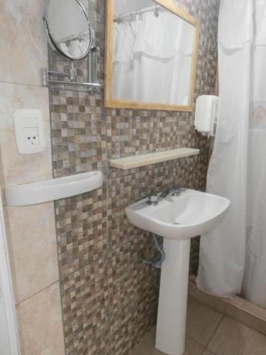 a bathroom with a sink and a mirror at Hotel Alma di Mare MDP in Mar del Plata