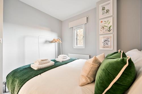 a bedroom with a large white bed with green sheets at Long Stays Angel Apartment with Terrace in London