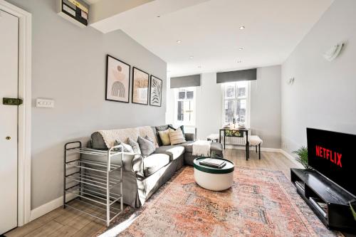 a living room with a couch and a tv at Long Stays Angel Apartment with Terrace in London
