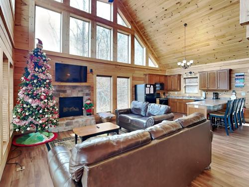 a living room with a christmas tree in a house at Back to Nature in Gatlinburg