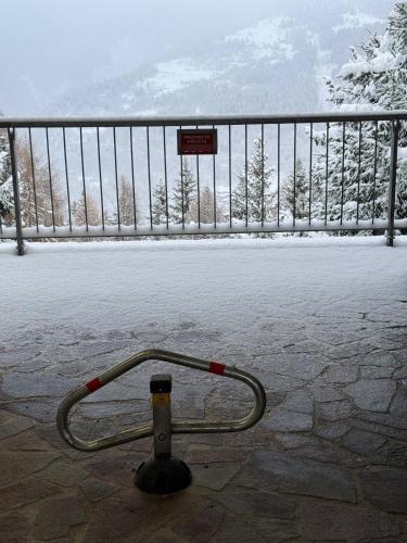 a hose hooked up to a fence in the snow at Panorama Marilleva 1400 - Val di Sole in Marilleva