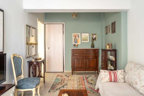 a living room with a couch and a table at Veranda at Patras Center Apartment in Patra