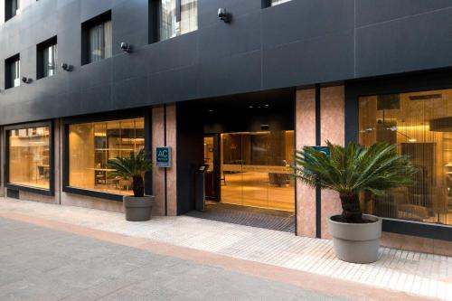 a building with two potted plants in front of it at AC Hotel by Marriott Tenerife in Santa Cruz de Tenerife