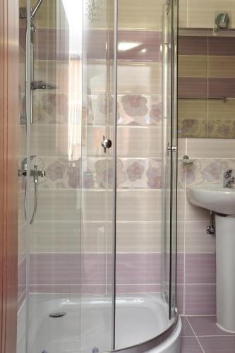 a bathroom with a shower and a sink at Lombardi Family Hotel in Ruse