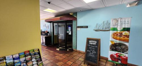a fast food restaurant with a sign on the wall at Quality Inn & Suites Gulf Breeze Bayside near Pensacola Beach in Gulf Breeze