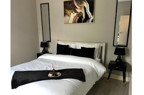 a bedroom with a white bed with a tray on it at City Chic Retreat In Birmingham in Birmingham