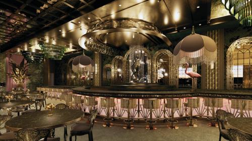 a restaurant with a bar with tables and chairs at Flamingo Las Vegas Hotel & Casino in Las Vegas