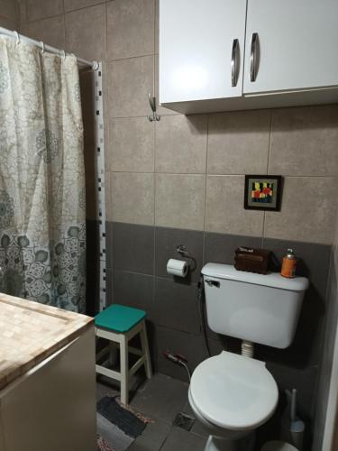 a bathroom with a white toilet and a shower at Alquilo casa dúplex!!! in Necochea