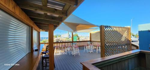 a deck with chairs and tables on a balcony at Quality Inn & Suites Gulf Breeze Bayside near Pensacola Beach in Gulf Breeze